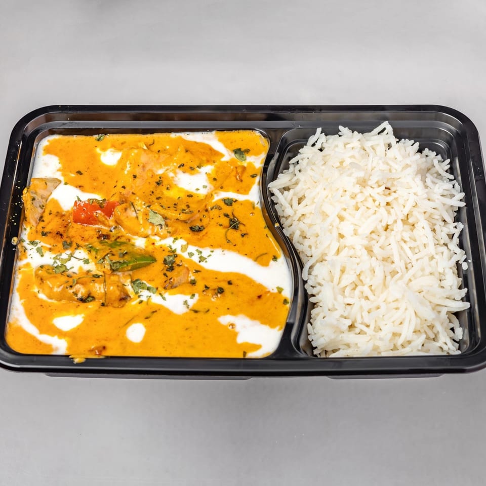 Spicy Chowk's Indian butter chicken with white rice in a black takeout container.